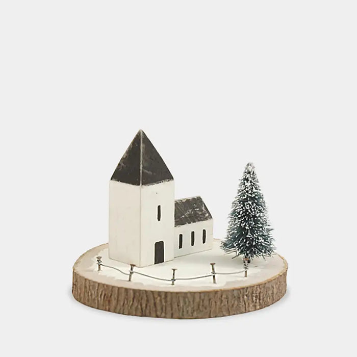 Model of a church with a Christmas tree on a wooden base against a white background