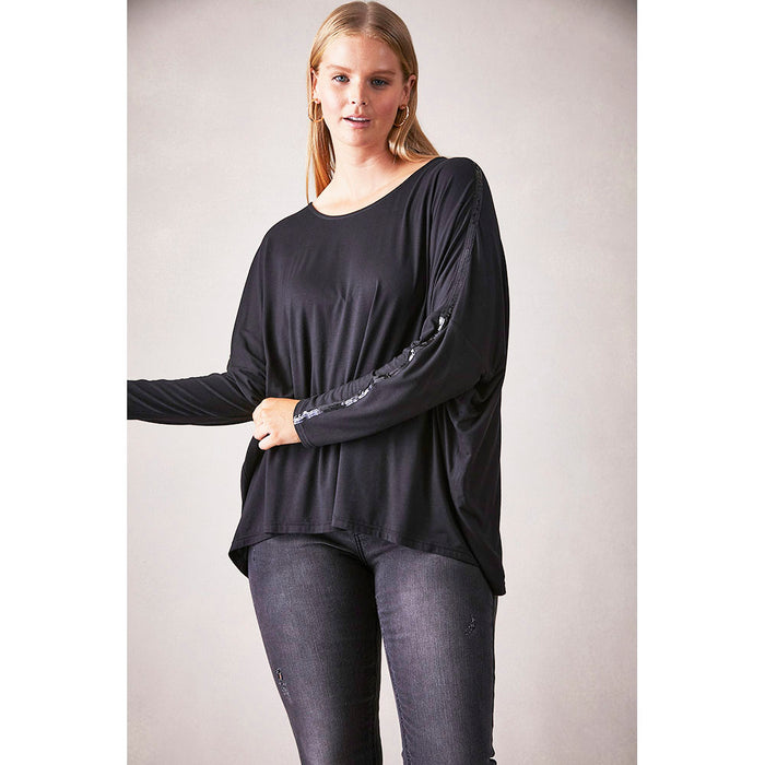 Eb and Ive top in raven colour. Loose fit and long sleeves. Sequined detail down sleeves. Front view. 