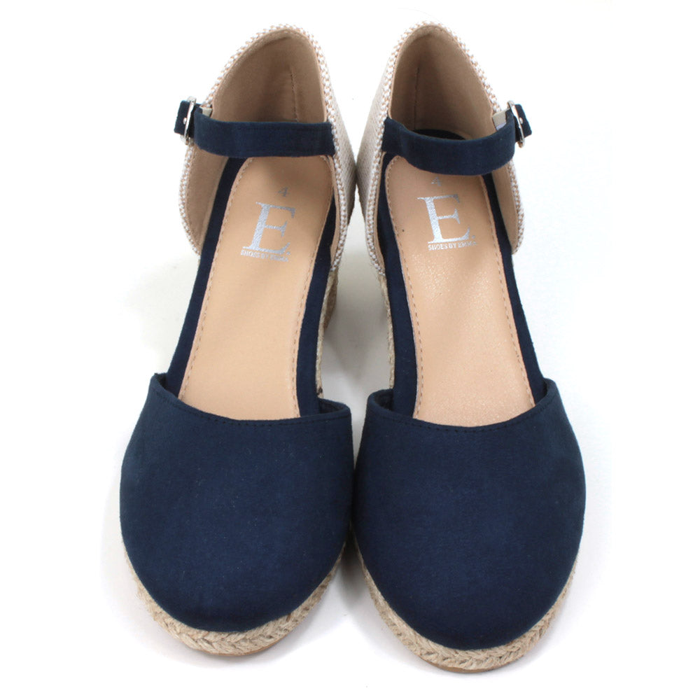 Heeled navy blue suede effect sandals. Slim ankle straps adjusted by small silver buckles. Espadrille soles. Front view.