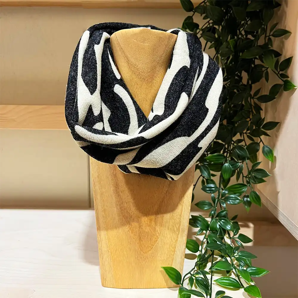 Black and ecru snood on a wooden stand