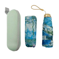 Foldable umbrella with abstract design and green case on a white background