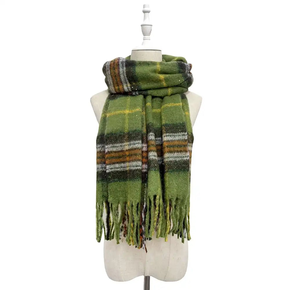 Green plaid scarf with fringes on a mannequin against a white background