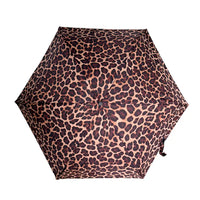 A top-down view of a compact umbrella with a leopard print pattern, featuring dark brown and black spots on a warm tan background, isolated on a white background.