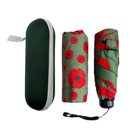 A compact umbrella set shown in three views on a white background: an open dark green case with a gray edge and a gray loop, a folded umbrella wrapped in olive green fabric with large red poppy flowers, and the umbrella closed diagonally showing the red-and-green floral pattern.