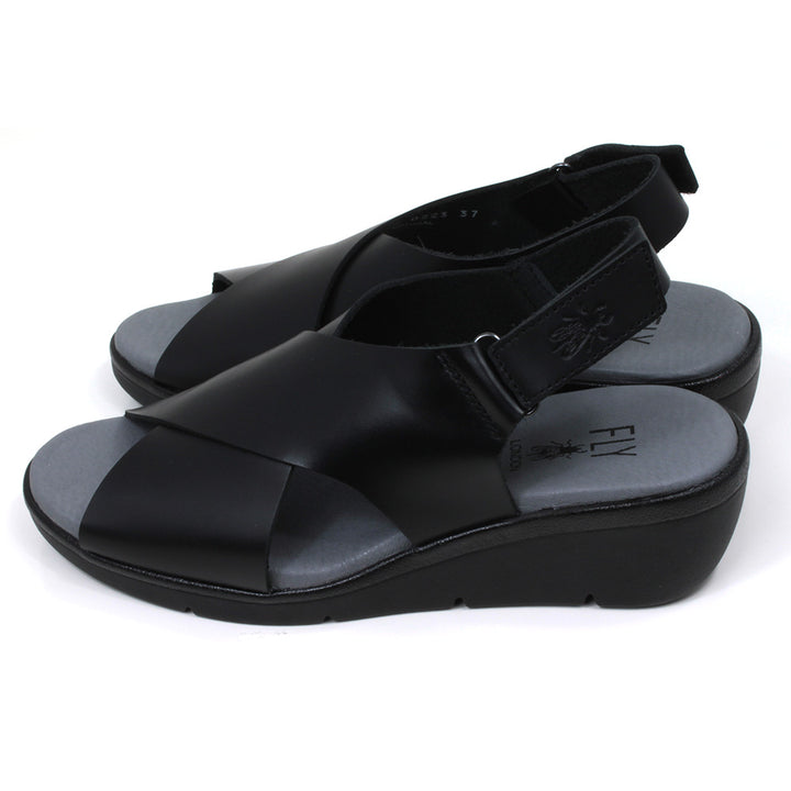 Fly London Bridle sandals in black. Cross over design over foot. Velcro fastening around the heel. Side view