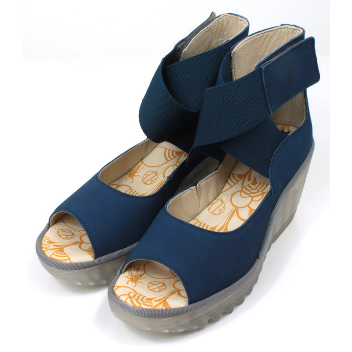 Fly London blue Cupido sandals with high ankle straps. Semi translucent platforms and  raised heels. Angled view