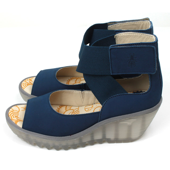 Fly London blue Cupido sandals with high ankle straps. Semi translucent platforms and  raised heels. Side view