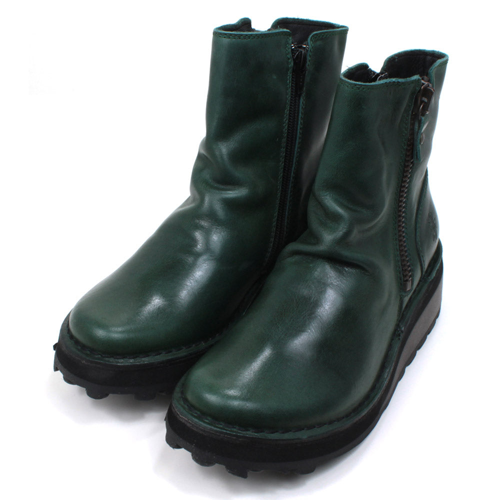 Fly London petrol coloured, zip fastening ankle boots with chunky black soles. Angled view.