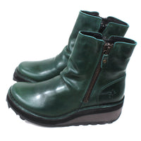 Fly London petrol coloured, zip fastening ankle boots with chunky black soles. Side view.