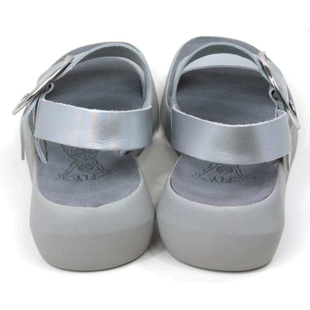 Fly London Mirror sandals in silver colour. Grey soles and footbeds. Large silver buckles on foot strap. Back view