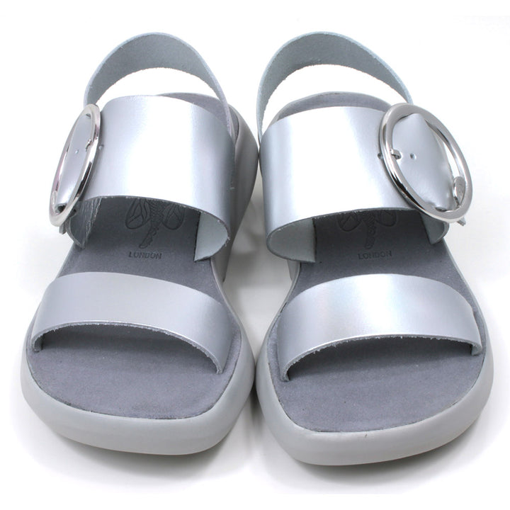 Fly London Mirror sandals in silver colour. Grey soles and footbeds. Large silver buckles on foot strap. Front view
