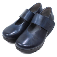 Fly London navy blue chunky wedge soled Mary Jane shoes with wrap over straps. Angled view.