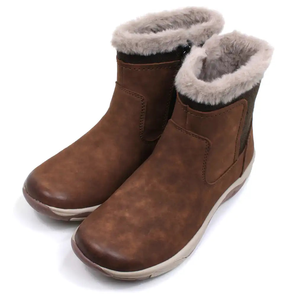 Free Spirit Charlie ankle boots in tan. Beige fur interior and around the ankle cuffs. Fabric to the rear. Zip up fitting. Angled view.