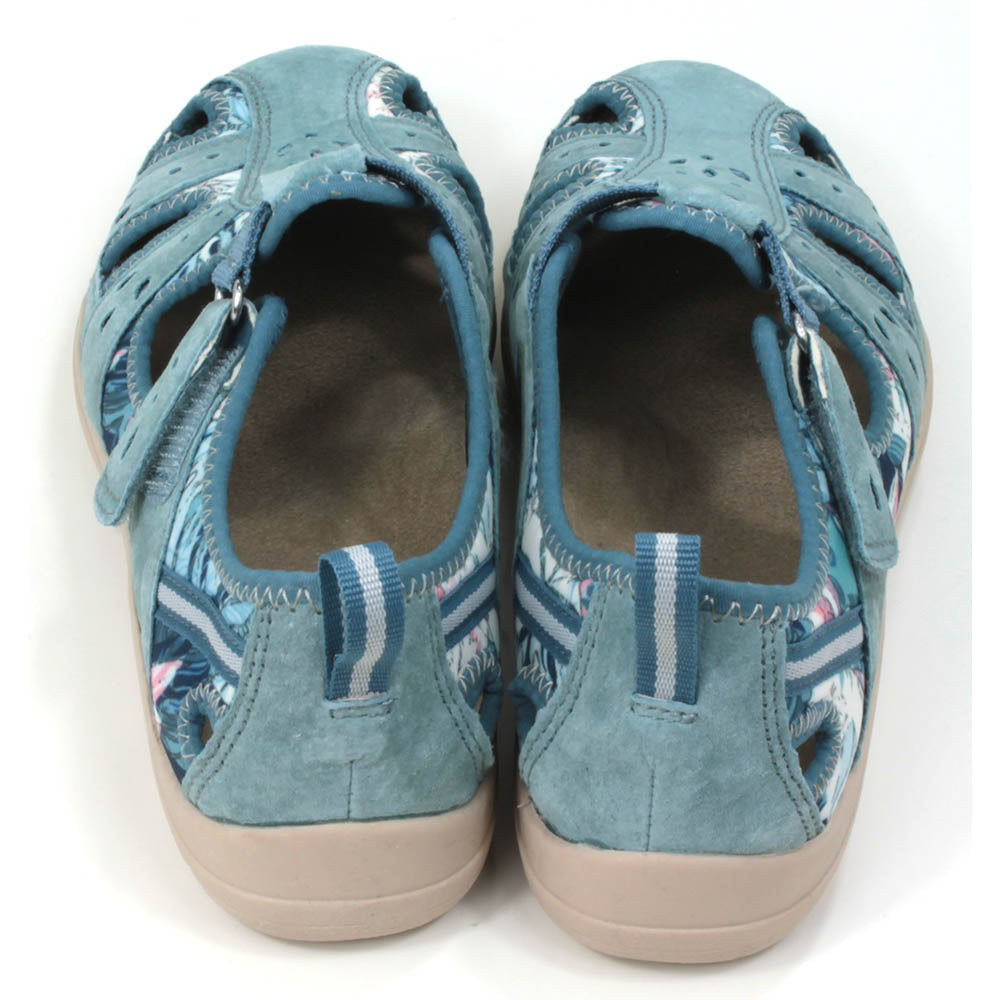 Sandals by Free Spirit in mid blue. Floral background pattern. Enclosed foot and heel design with back tabs to assist fitting. Low heels. Back view