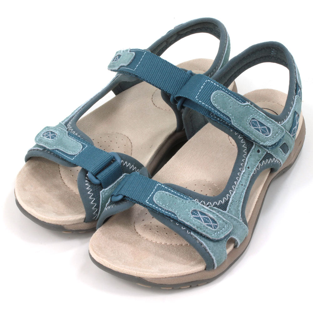 Moroccan blue walking sandals with pale beige padded insoles. Velcro adjustable straps. Angled view.