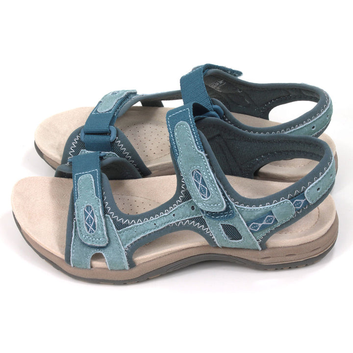 Moroccan blue walking sandals with pale beige padded insoles. Velcro adjustable straps. Side view.