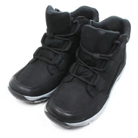 Free Spirit Gem low ankle boots in black. Lace ups with grey edges on black soles. Padded ankle cuffs. Angled view.