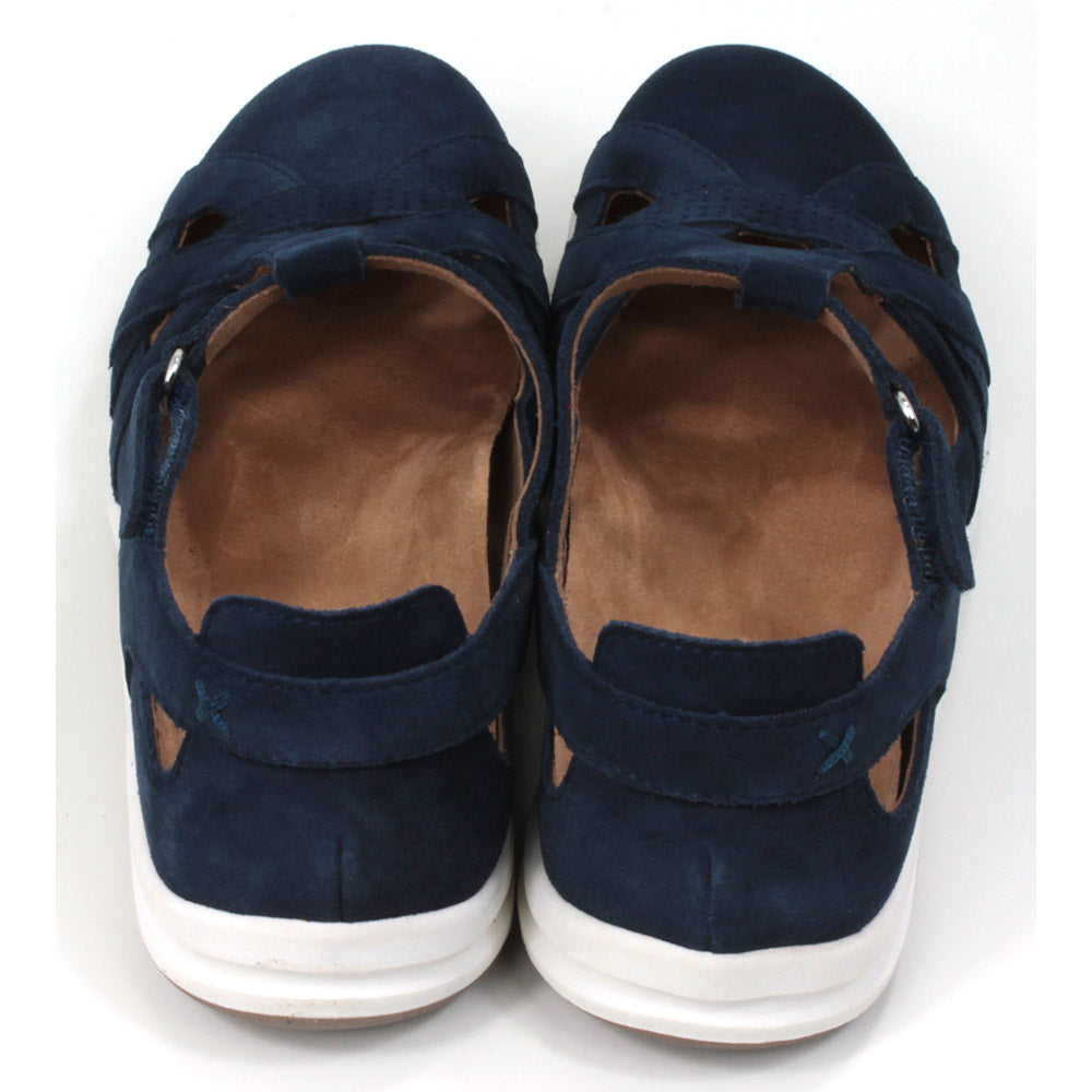 Full foot and heel covering sandals in navy blue suede leather. White soles. Adjustable velcro straps. Back view.