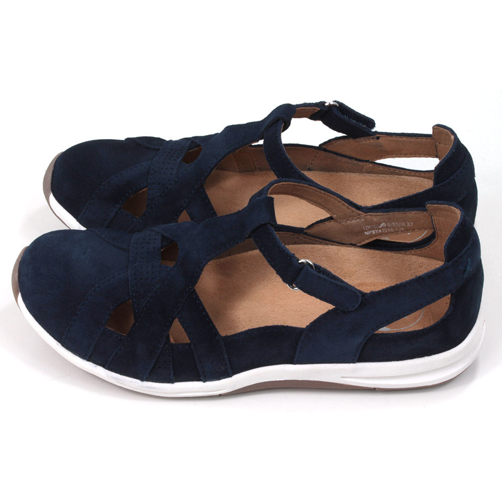 Full foot and heel covering sandals in navy blue suede leather. White soles. Adjustable velcro straps. Side view.