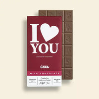A chocolate bar peering out from the cover of maroon coloured packaging. Maroon packaging features a saying of 'I love you (More than chocolate)'.