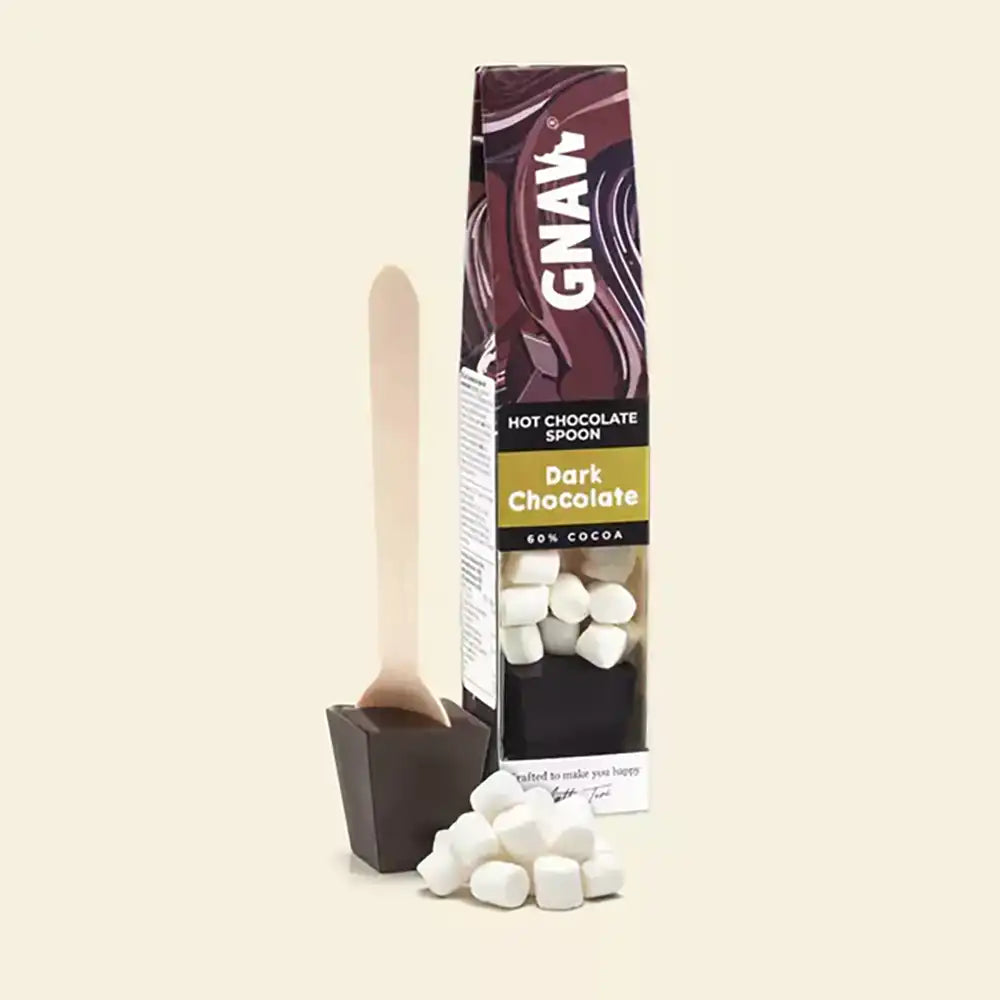 GNAW hot chocolate set with spoon and marshmallows on a beige background