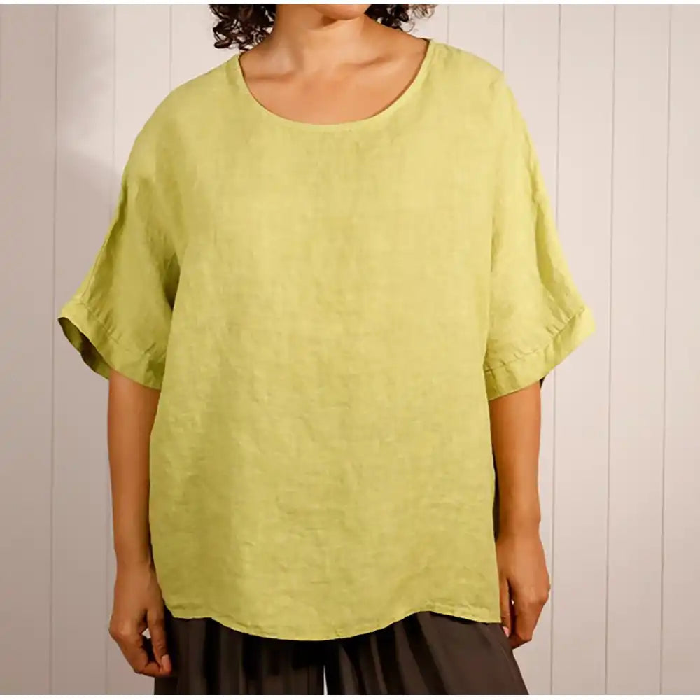 Person wearing a light green shirt against a neutral background