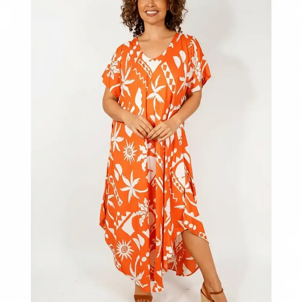 Woman wearing an orange dress with an abstract pattern