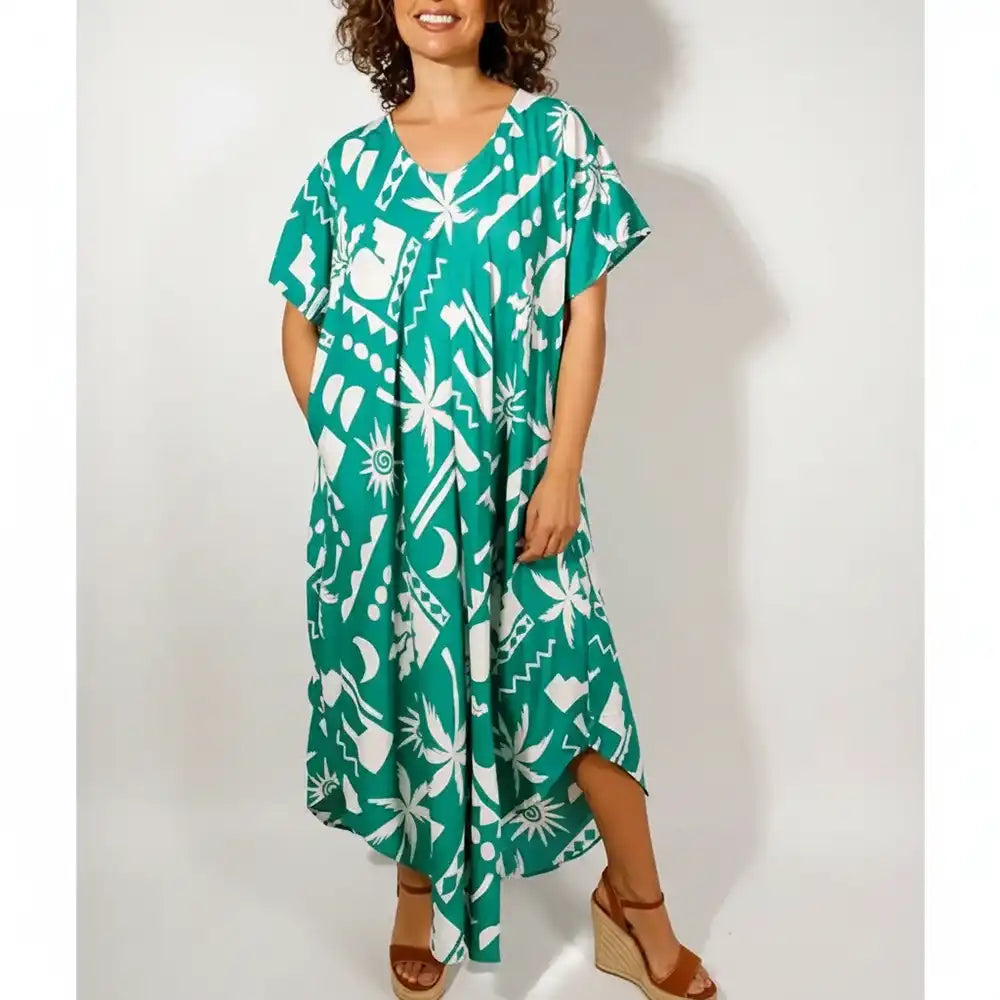 Woman wearing dress with abstract green pattern.