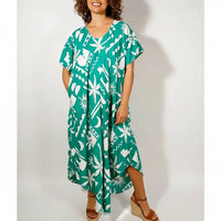 Woman wearing dress with abstract green pattern.