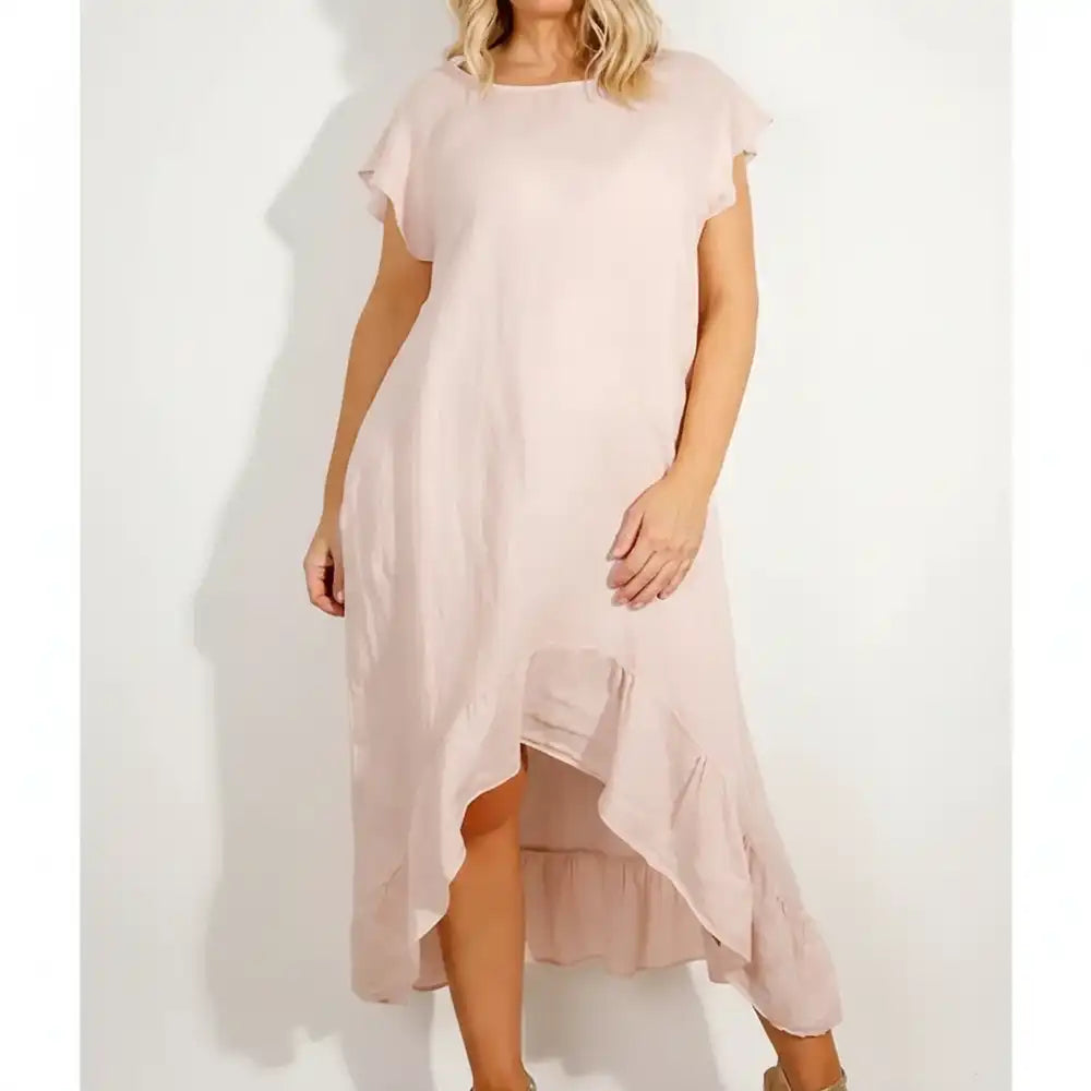 Woman wearing a pink frilled dress.