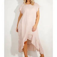 Woman wearing a pink frilled dress.