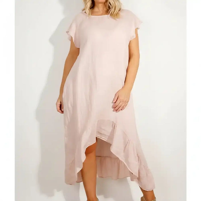 Woman wearing a pink frilled dress.