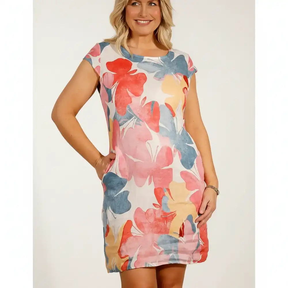 Woman wearing a short cap sleeved dress with large butterfly pattern