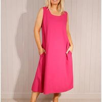Woman wearing a pink dress against a plain background
