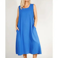 Woman wearing a blue sleevless over the knee dress.