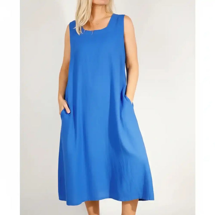 Woman wearing a blue sleevless over the knee dress.