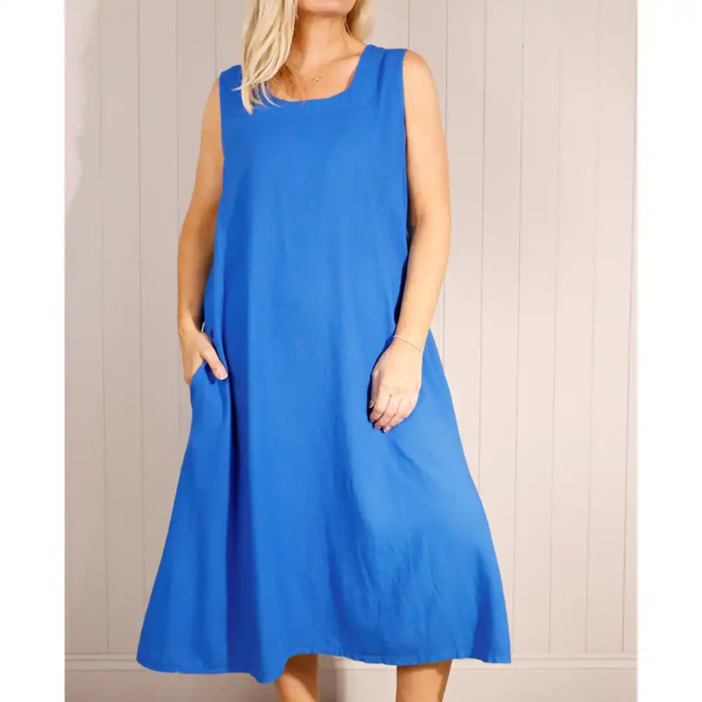 Woman wearing a royal blue dress against a plain background
