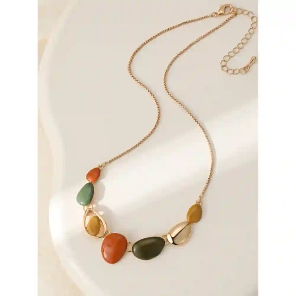 Gold coloured chain leading to pebble shaped gems in orange, sage and mustarf.