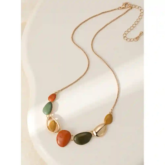 Gold coloured chain leading to pebble shaped gems in orange, sage and mustarf.