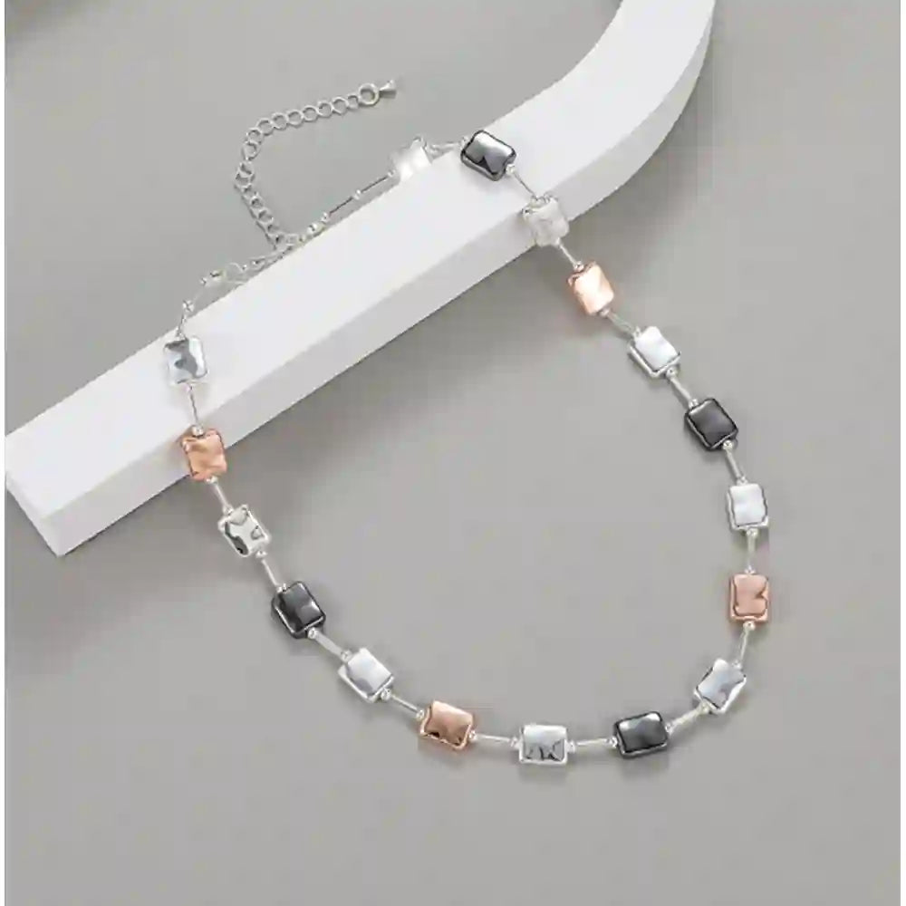 Mixed metal necklace with square beads on it