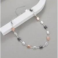 Mixed metal necklace with square beads on it