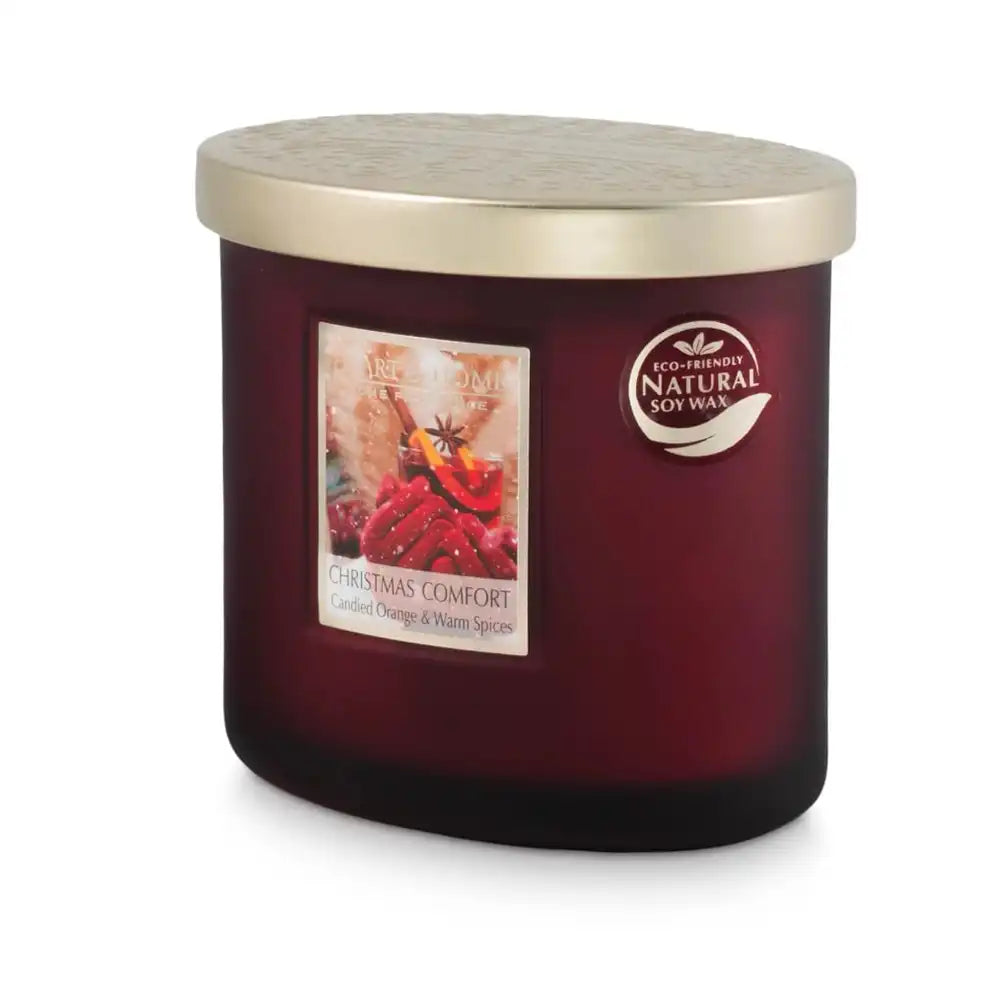 A jar candle with a dark burgundy glass body, a textured metallic gold lid, 