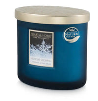 Heart & Home Midnight Snowfall home fragrance soy candle in a dark blue glass jar with a metallic gold lid, featuring a white label with snowflake graphics and a circular natural soy wax badge.