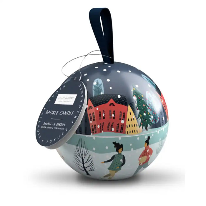 Decorative Christmas ball with a winter scene and people, featuring a candle inside.