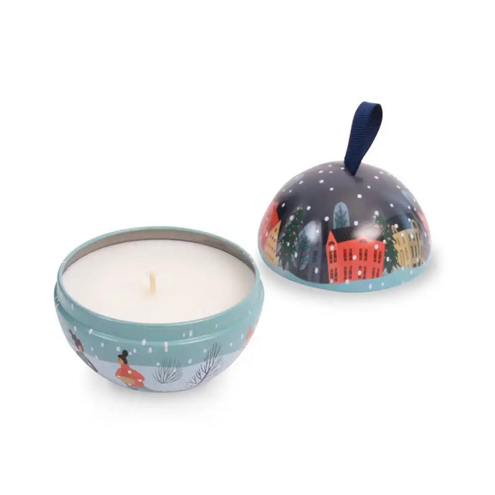 Candle in a decorative tin with a lid featuring a winter scene.