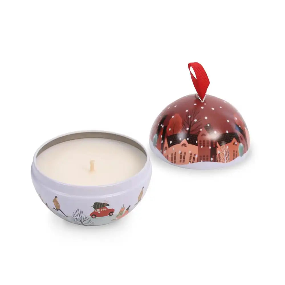 Candle in a decorative tin with a festive design on a white background