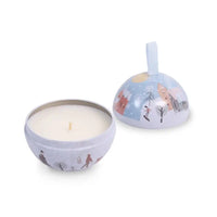 Candle in a decorative tin with winter scene design on a white background