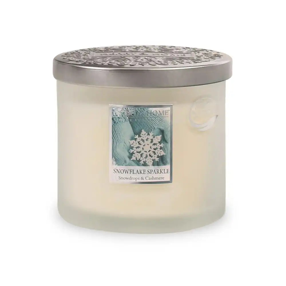 Frosted candle with a decorative label on a white background