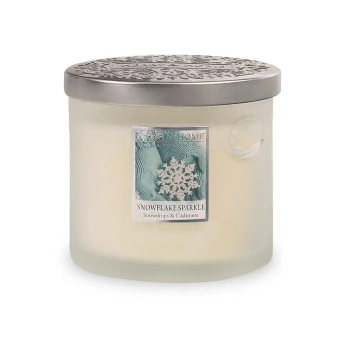 Frosted candle with a decorative label on a white background