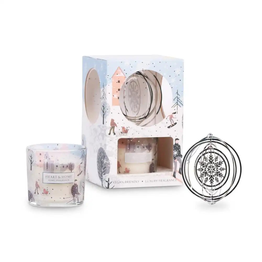 Candle with packaging featuring winter scene design on a white background
